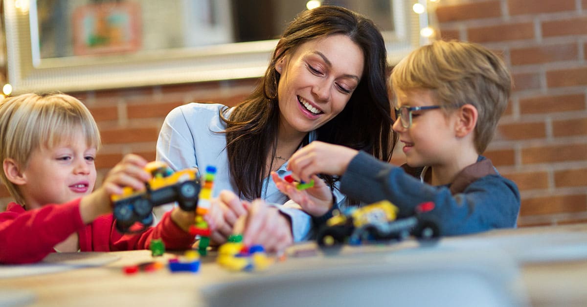 mom and kids playing with Legos